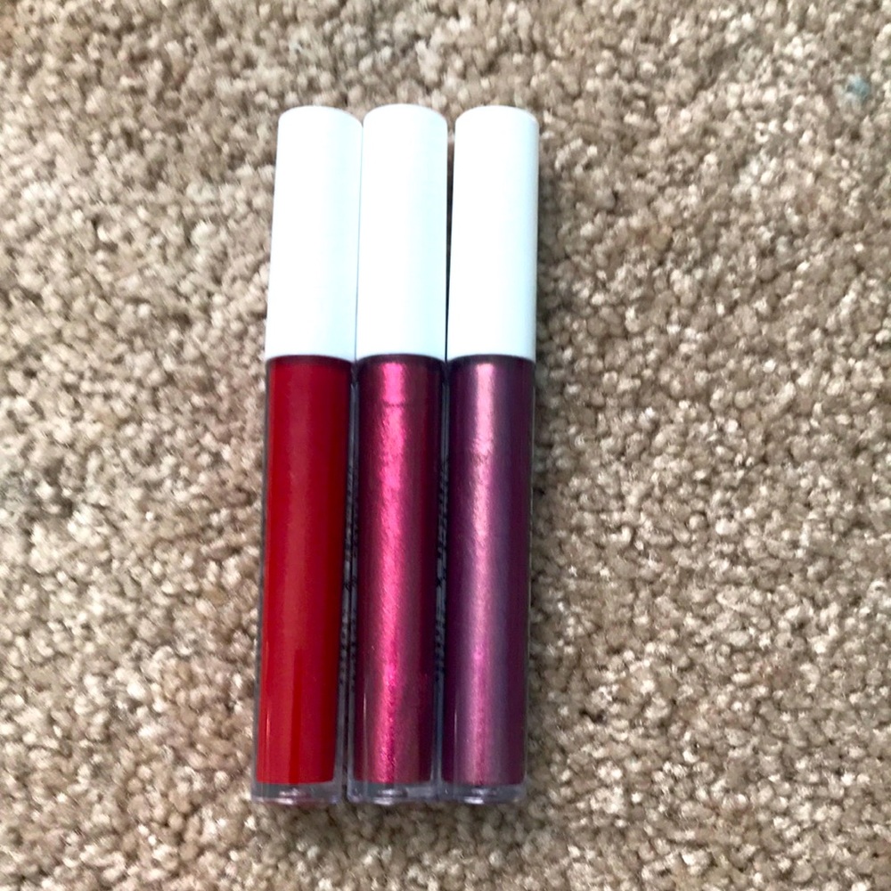 3 brightly colored lip glosses